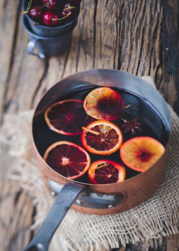 close-up photography of sliced orange fruit on brown cooking pot